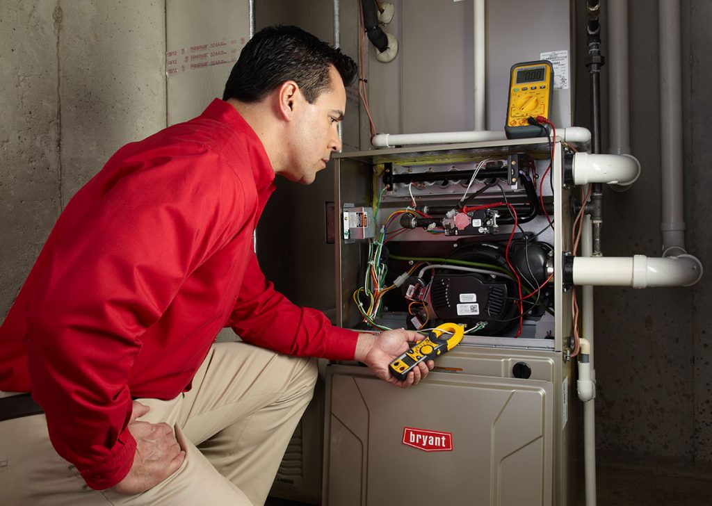 HVAC technician repairing an indoor furnace in Drexel Heights