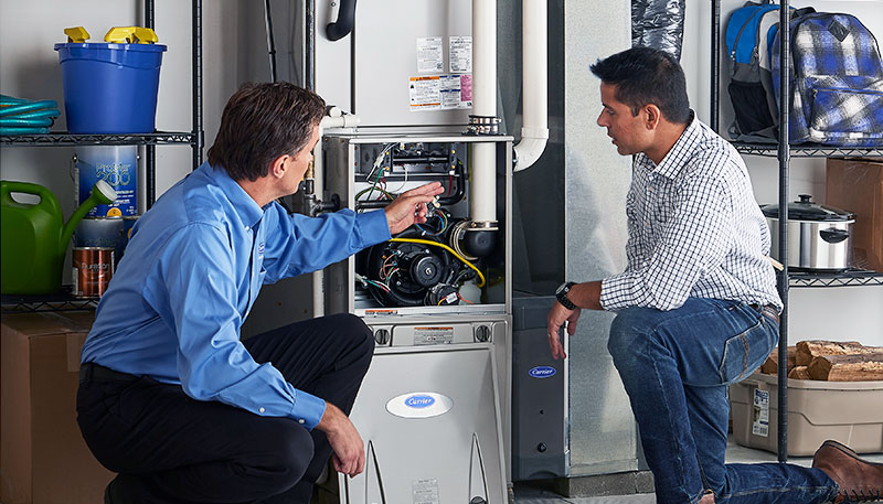 HVAC technician evaluating a furnace for repair or replacement in Drexel Heights