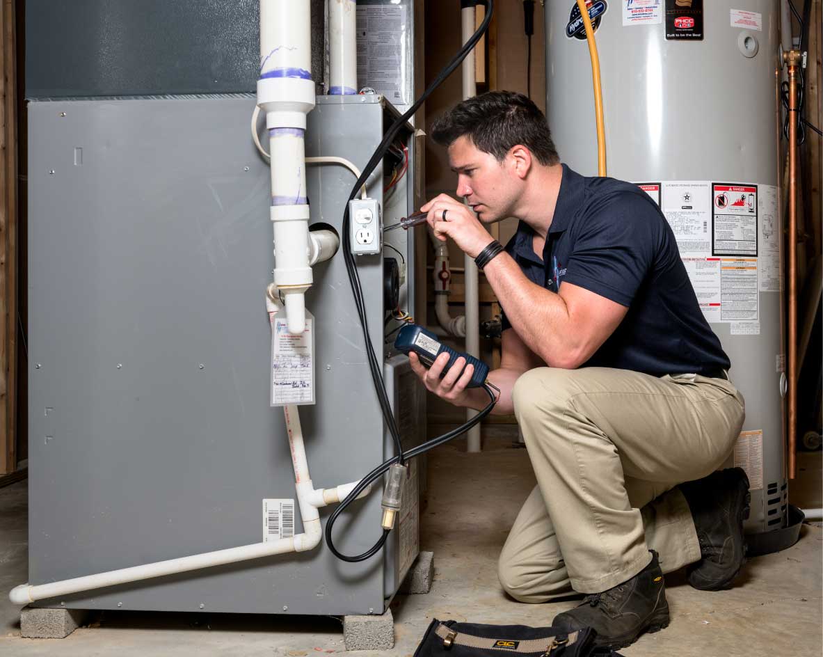 HVAC technician performing a furnace tune-up in Drexel Heights