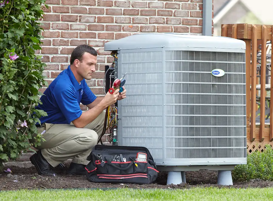 HVAC technician inspecting an outdoor air conditioning unit in Drexel Heights