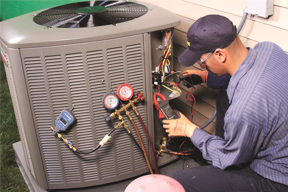 HVAC technician testing an outdoor air conditioning unit in Drexel Heights