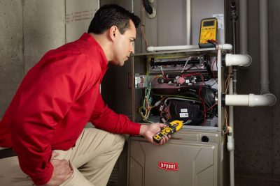 furnace repair Heating and air conditioning technician servicing an indoor furnace in Drexel Heights, AZ